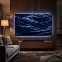 Samsung 75-inch 4K TV wall-mounted in a premium home-theater living room at night, cinematic movie on screen