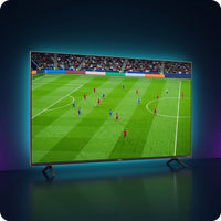 VIZIO 65-inch QLED Quantum 4K TV showing a vivid live soccer match, premium dark studio with cyan glow